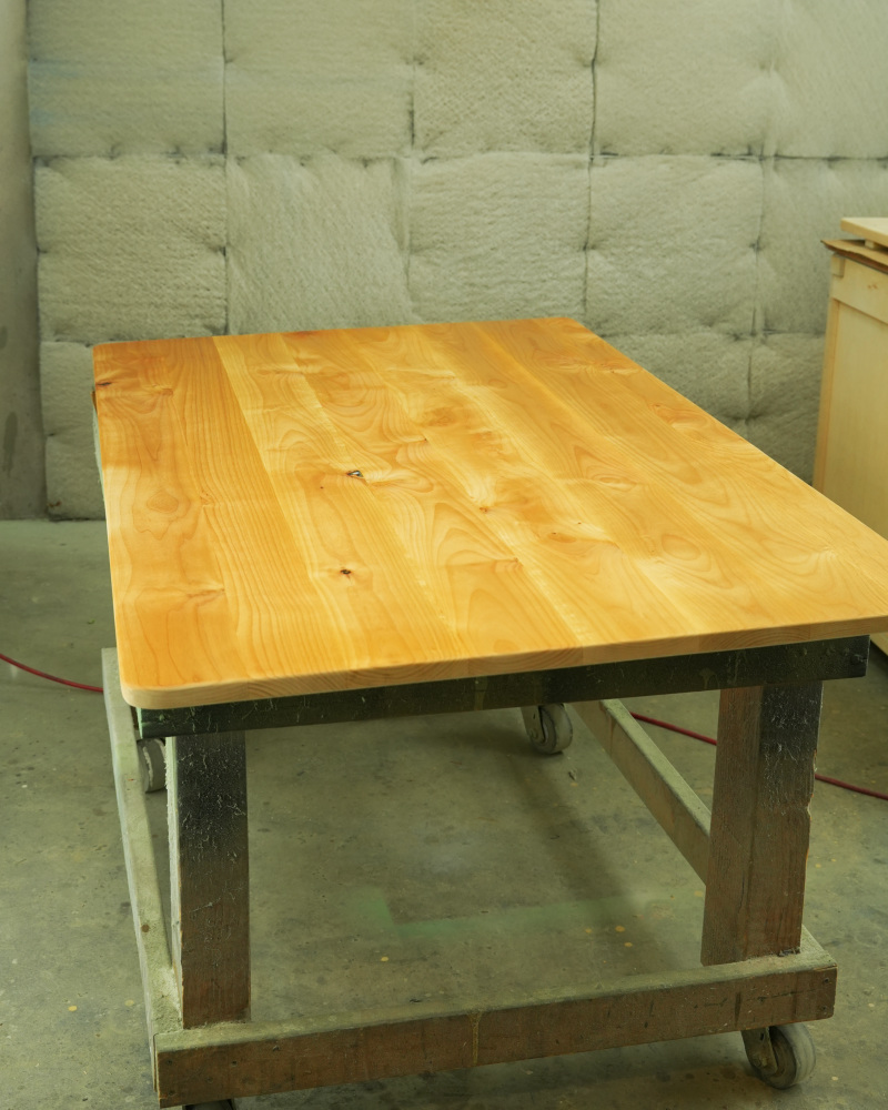 Finished solid wood tabletop showing the grain under a clear finish