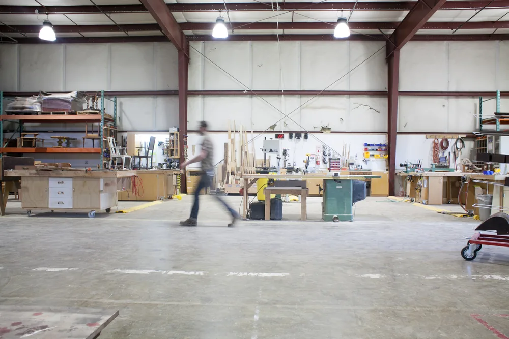 Inside G. Michael's Fort Collins furniture restoration workshop with woodworking benches and equipment