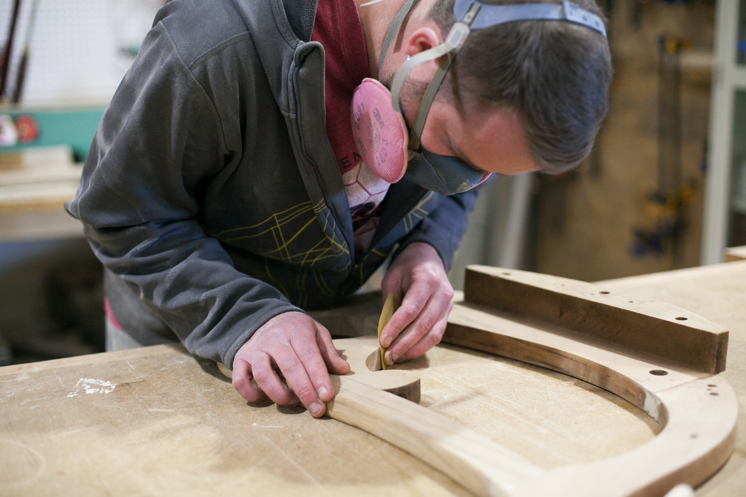 Craftsperson repairing a chair frame in G. Michael's studio