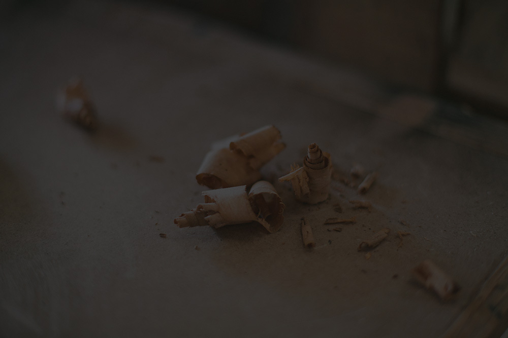 Fine wood shavings on a G. Michael's workbench